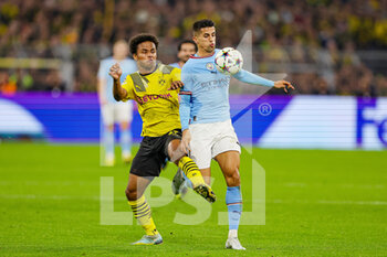 2022-10-25 - Joao Cancelo (7) of Manchester City holds off Karim Adeyemi (27) of Borussia Dortmund during the UEFA Champions League, Group G football match between Borussia Dortmund and Manchester City on October 25, 2022 at Signal Iduna Park in Dortmund, Germany - FOOTBALL - CHAMPIONS LEAGUE - DORTMUND V MANCHESTER CITY - UEFA CHAMPIONS LEAGUE - SOCCER