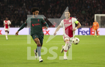 2022-10-26 - Joe Gomez of Liverpool, Dusan Tadic of Ajax during the UEFA Champions League, Group A football match between Ajax Amsterdam and Liverpool FC on October 26, 2022 at Johan Cruijff ArenA in Amsterdam, Netherlands - FOOTBALL - CHAMPIONS LEAGUE - AJAX V LIVERPOOL - UEFA CHAMPIONS LEAGUE - SOCCER