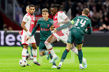 2022-10-26 - Roberto Firmino of Liverpool FC, Calvin Bassey of Ajax, Jordan Henderson of Liverpool FC during the UEFA Champions League, Group A football match between Ajax and Liverpool on October 26, 2022 at Johan Cruijff ArenA in Amsterdam, Netherlands - FOOTBALL - CHAMPIONS LEAGUE - AJAX V LIVERPOOL - UEFA CHAMPIONS LEAGUE - SOCCER