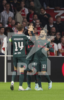 2022-10-26 - Mohamed Salah of Liverpool (right) celebrates his goal with Jordan Henderson of Liverpool during the UEFA Champions League, Group A football match between Ajax Amsterdam and Liverpool FC on October 26, 2022 at Johan Cruijff ArenA in Amsterdam, Netherlands - FOOTBALL - CHAMPIONS LEAGUE - AJAX V LIVERPOOL - UEFA CHAMPIONS LEAGUE - SOCCER