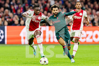2022-10-26 - Calvin Bassey of Ajax, Mohamed Salah of Liverpool during the UEFA Champions League, Group A football match between Ajax and Liverpool on October 26, 2022 at Johan Cruijff ArenA in Amsterdam, Netherlands - FOOTBALL - CHAMPIONS LEAGUE - AJAX V LIVERPOOL - UEFA CHAMPIONS LEAGUE - SOCCER