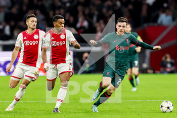 2022-10-26 - Dusan Tadic, Jurrien Timber of Ajax, Andy Robertson of Liverpool during the UEFA Champions League, Group A football match between Ajax and Liverpool on October 26, 2022 at Johan Cruijff ArenA in Amsterdam, Netherlands - FOOTBALL - CHAMPIONS LEAGUE - AJAX V LIVERPOOL - UEFA CHAMPIONS LEAGUE - SOCCER