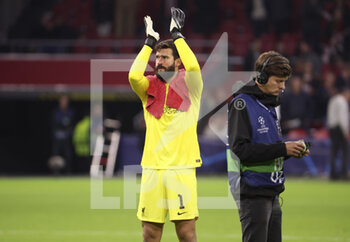 2022-10-26 - Goalkeeper of Liverpool Alisson Becker celebrates the victory with the supporters following the UEFA Champions League, Group A football match between Ajax Amsterdam and Liverpool FC on October 26, 2022 at Johan Cruijff ArenA in Amsterdam, Netherlands - FOOTBALL - CHAMPIONS LEAGUE - AJAX V LIVERPOOL - UEFA CHAMPIONS LEAGUE - SOCCER