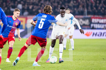 2022-03-17 - BASEL, SWITZERLAND - MARCH 17: Pape Gueye of Marseille (R) against Michael Lang of Basel (L) during the UEFA Conference League Round of 16 Leg Two match between FC Basel and Olympique Marseille at  on March 17, 2022 in Basel, Switzerland. - FC BASEL AND OLYMPIQUE MARSEILLE - UEFA CONFERENCE LEAGUE - SOCCER
