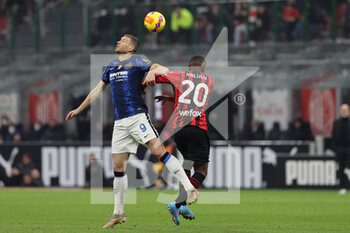 2022-03-01 - Edin Dzeko of FC Internazionale fights for the ball against Pierre Kalulu of AC Milan during the Coppa Italia 2021/22 football match between AC Milan and FC Internazionale at Giuseppe Meazza Stadium, Milan, Italy on March 01, 2022 - AC MILAN VS FC INTERNAZIONALE - ITALIAN CUP - SOCCER