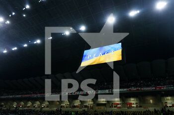 2022-03-01 - The LED screen inside the stadium shows an Ukrainian flag to indicate peace message for Ukraine during the Coppa Italia 2021/22 football match between AC Milan and FC Internazionale at Giuseppe Meazza Stadium, Milan, Italy on March 01, 2022 - AC MILAN VS FC INTERNAZIONALE - ITALIAN CUP - SOCCER