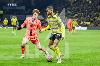 2022-01-21 - Joao Pedro (10) of Watford battles with Josh Sargent (24) of Norwich City during the English championship Premier League football match between Watford and Norwich City on January 21, 2022 at Vicarage Road in Watford, England - WATFORD VS NORWICH CITY - ENGLISH PREMIER LEAGUE - SOCCER