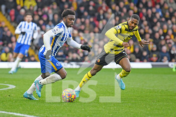 2022-02-12 - Brighton and Hove Albion defender Tariq Lamptey (2) under pressure from Watford forward Emmanuel Dennis during the English championship Premier League football match between Watford and Brighton and Hove Albion on February 12, 2022 at Vicarage Road in Watford, England - WATFORD VS BRIGHTON AND HOVE ALBION - ENGLISH PREMIER LEAGUE - SOCCER
