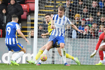 2022-02-12 - Watford defender Craig Cathcart (15) and Brighton and Hove Albion defender Adam Webster (4) during the English championship Premier League football match between Watford and Brighton and Hove Albion on February 12, 2022 at Vicarage Road in Watford, England - WATFORD VS BRIGHTON AND HOVE ALBION - ENGLISH PREMIER LEAGUE - SOCCER