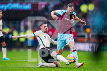 2022-02-13 - Liverpool midfielder Jordan Henderson (14) tackles Burnley defender Erik Pieters (23) during the English championship Premier League football match between Burnley and Liverpool on February 13, 2022 at Turf Moor in Burnley, England - BURNLEY VS LIVERPOOL - ENGLISH PREMIER LEAGUE - SOCCER
