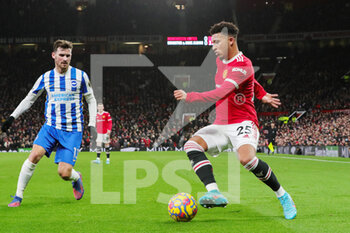 2022-02-16 - Manchester United Midfielder Jadon Sancho (25) battles with Brighton and Hove Albion midfielder Pascal Gross (13) during the English championship Premier League football match between Manchester United and Brighton and Hove Albion on February 15, 2022 at Old Trafford in Manchester, England - MANCHESTER UNITED VS BRIGHTON AND HOVE ALBION - ENGLISH PREMIER LEAGUE - SOCCER