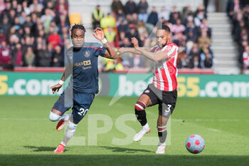 2022-03-12 - Burnley midfielder Maxwel Cornet (20) and Brentford defender Rico Henry (3) during the English championship Premier League football match between Brentford and Burnley on March 12, 2022 at Brentford Community Stadium in Brentford, England - BRENTFORD VS BURNLEY - ENGLISH PREMIER LEAGUE - SOCCER
