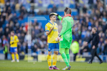 2022-03-12 - Brighton and Hove Albion striker Neal Maupay and Liverpool goalkeeper Alisson Becker after the English championship Premier League football match between Brighton and Hove Albion and Liverpool on March 12, 2022 at the American Express Community Stadium in Brighton and Hove, England - BRIGHTON AND HOVE ALBION VS LIVERPOOL - ENGLISH PREMIER LEAGUE - SOCCER