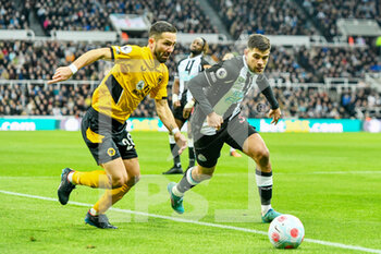 2022-04-08 - Newcastle United's Bruno Guimaraes takes on Wolves Joao Moutinho during the English championship Premier League football match between Newcastle United and Wolverhampton Wanderers on April 8, 2022 at St James' Park in Newcastle, England - NEWCASTLE UNITED VS WOLVERHAMPTON WANDERERS - ENGLISH PREMIER LEAGUE - SOCCER