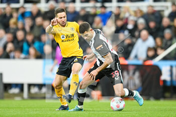 2022-04-08 - Wolves Joao Moutinho tackles Newcastle United's Bruno Guimaraes during the English championship Premier League football match between Newcastle United and Wolverhampton Wanderers on April 8, 2022 at St James' Park in Newcastle, England - NEWCASTLE UNITED VS WOLVERHAMPTON WANDERERS - ENGLISH PREMIER LEAGUE - SOCCER