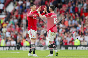 2022-04-17 - Manchester United Forward Cristiano Ronaldo (7) and Manchester United Midfielder Bruno Fernandes (18) celebrate at the end of the English championship Premier League football match between Manchester United and Norwich City on April 16, 2022 at Old Trafford in Manchester, England - MANCHESTER UNITED VS NORWICH CITY - ENGLISH PREMIER LEAGUE - SOCCER
