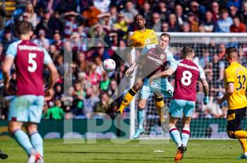 2022-04-24 - Wolverhampton Wanderers defender Willy Boly (15) wrestles with Burnley forward Ashley Barnes (10) during the English championship Premier League football match between Burnley and Wolverhampton Wanderers on April 24, 2022 at Turf Moor in Burnley, England - BURNLEY VS WOLVERHAMPTON WANDERERS - ENGLISH PREMIER LEAGUE - SOCCER