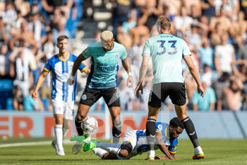 2022-08-13 - Newcastle United forward Joelinton (7) gets the ball from Brighton and Hove Albion defender Tariq Lamptey (2) during the English championship Premier League football match between Brighton and Hove Albion and Newcastle United on August 13, 2022 at the American Express Community Stadium in Brighton and Hove, England - FOOTBALL - ENGLISH CHAMP - BRIGHTON V NEWCASTLE - ENGLISH PREMIER LEAGUE - SOCCER