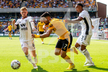 2022-08-13 - Fulham defender Kenny Tete (2) grabs Wolverhampton Wanderers forward Pedro Neto (7) shirt during the English championship Premier League football match between Wolverhampton Wanderers and Fulham on August 13, 2022 at Molineux in Wolverhampton, England - FOOTBALL - ENGLISH CHAMP - WOLVERHAMPTON V FULHAM - ENGLISH PREMIER LEAGUE - SOCCER