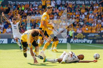 2022-08-13 - Penalty for Fulham after Wolverhampton Wanderers defender Rayan Ait-Nouri (3) fouls Fulham midfielder Bobby Reid (14) during the English championship Premier League football match between Wolverhampton Wanderers and Fulham on August 13, 2022 at Molineux in Wolverhampton, England - FOOTBALL - ENGLISH CHAMP - WOLVERHAMPTON V FULHAM - ENGLISH PREMIER LEAGUE - SOCCER