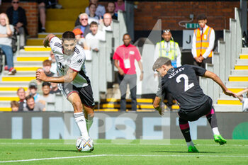 2022-08-20 - Fulham forward Aleksandar Mitrovic (9) goes past Brentford defender Aaron Hickey (2) during the English championship Premier League football match between Fulham and Brentford on August 20, 2022 at Craven Cottage in London, England - FOOTBALL - ENGLISH CHAMP - FULHAM V BRENTFORD - ENGLISH PREMIER LEAGUE - SOCCER