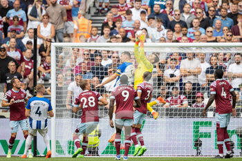 2022-08-21 - West Ham United goalkeeper Lukasz Fabianski (1) saves the ball, Lewis Dunk of Brighton during the English championship Premier League football match between West Ham United and Brighton and Hove Albion on August 21, 2022 at the London Stadium in London, England - FOOTBALL - ENGLISH CHAMP - WEST HAM V BRIGHTON - ENGLISH PREMIER LEAGUE - SOCCER