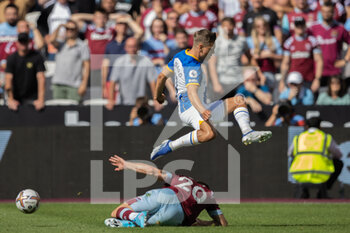 2022-08-21 - Brighton and Hove Albion midfielder Leandro Trossard (11) flies over the top of West Ham United striker Jarrod Bowen (20) during the English championship Premier League football match between West Ham United and Brighton and Hove Albion on August 21, 2022 at the London Stadium in London, England - FOOTBALL - ENGLISH CHAMP - WEST HAM V BRIGHTON - ENGLISH PREMIER LEAGUE - SOCCER
