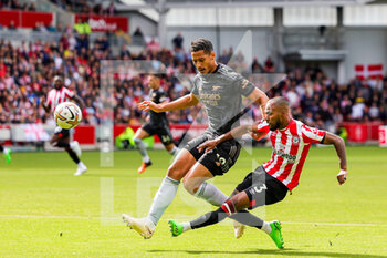 2022-09-18 - Rico Henry (3) of Brentford and William Saliba (12) of Arsenal during the Premier League match between Brentford and Arsenal at Gtech Community Stadium, Brentford, England on 18 September 2022. Photo Nigel Keene / ProSportsImages / DPPI - FOOTBALL - ENGLISH CHAMP - BRENTFORD V ARSENAL - ENGLISH PREMIER LEAGUE - SOCCER