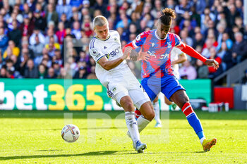 2022-10-09 - Rasmus Kristensen (25) of Leeds United tussles with Wilfried Zaha (11) of Crystal Palace during the English championship Premier League football match between Crystal Palace and Leeds United on October 9, 2022 at Selhurst Park in London, England - FOOTBALL - ENGLISH CHAMP - CRYSTAL PALACE V LEEDS - ENGLISH PREMIER LEAGUE - SOCCER