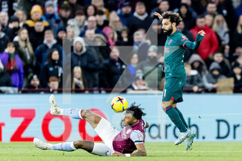 2022-12-26 - Liverpool forward Mohamed Salah (11) battles for possession with Aston Villa defender Tyrone Mings (5) during the English championship Premier League football match between Aston Villa and Liverpool on December 26, 2022 at Villa Park in Birmingham, England - FOOTBALL - ENGLISH CHAMP - ASTON VILLA V LIVERPOOL - ENGLISH PREMIER LEAGUE - SOCCER