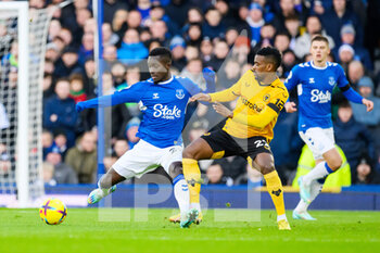 2022-12-26 - Everton's Idrissa Gana Gueye holds off Wolves Nelson Semedo during the English championship Premier League football match between Everton and Wolverhampton Wanderers on December 26, 2022 at Goodison Park in Liverpool, England - FOOTBALL - ENGLISH CHAMP - EVERTON V WOLVERHAMPTON - ENGLISH PREMIER LEAGUE - SOCCER