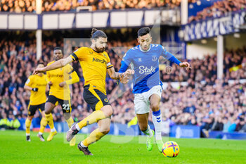 2022-12-26 - Wolves Ruben Neves tackles Everton's Dwight McNeil during the English championship Premier League football match between Everton and Wolverhampton Wanderers on December 26, 2022 at Goodison Park in Liverpool, England - FOOTBALL - ENGLISH CHAMP - EVERTON V WOLVERHAMPTON - ENGLISH PREMIER LEAGUE - SOCCER
