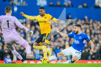 2022-12-26 - Wolves Nelson Semedo tackles Everton's Neal Maupay as Wolves goalkeeper Jose Sa comes out during the English championship Premier League football match between Everton and Wolverhampton Wanderers on December 26, 2022 at Goodison Park in Liverpool, England - FOOTBALL - ENGLISH CHAMP - EVERTON V WOLVERHAMPTON - ENGLISH PREMIER LEAGUE - SOCCER