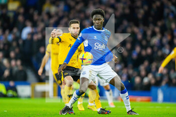 2022-12-26 - Everton's Amadou Onana shields the ball from Wolves Joao Moutinho during the English championship Premier League football match between Everton and Wolverhampton Wanderers on December 26, 2022 at Goodison Park in Liverpool, England - FOOTBALL - ENGLISH CHAMP - EVERTON V WOLVERHAMPTON - ENGLISH PREMIER LEAGUE - SOCCER