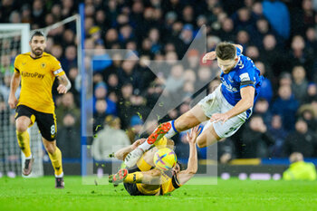 2022-12-26 - Wolves Diego Costa slide tackles Everton's James Tarkowski during the English championship Premier League football match between Everton and Wolverhampton Wanderers on December 26, 2022 at Goodison Park in Liverpool, England - FOOTBALL - ENGLISH CHAMP - EVERTON V WOLVERHAMPTON - ENGLISH PREMIER LEAGUE - SOCCER