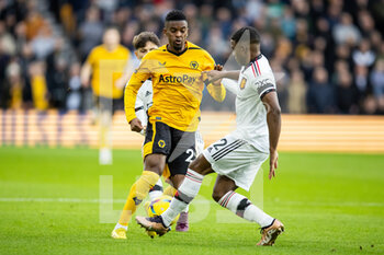2022-12-31 - Wolverhampton Wanderers defender Nelson Semedo (22) battles for possession with Manchester United defender Tyrell Malacia during the English championship Premier League football match between Wolverhampton Wanderers and Manchester United on 31 December 2022 at Molineux stadium in Wolverhampton, England - FOOTBALL - ENGLISH CHAMP - WOLVERHAMPTON V MANCHESTER UNITED - ENGLISH PREMIER LEAGUE - SOCCER