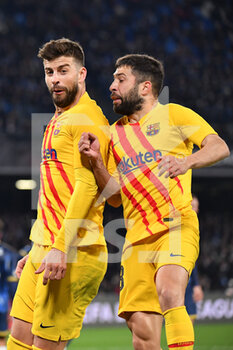 2022-02-24 - Barcelona's defender Gerard Pique celebrates with Barcelona's defender Jordi Alba after scoring the 1-3 goal  - SSC NAPOLI VS FC BARCELLONA - UEFA EUROPA LEAGUE - SOCCER