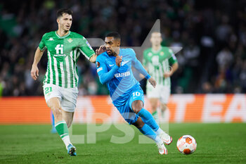 2022-02-24 - Guido Rodriguez of Real Betis and Malcom Filipe of Zenit during the UEFA Europa League, Play-off, 2nd leg football match between Real Betis and Zenit on February 24, 2022 at Ramon Sanchez-Pizjuan stadium in Sevilla, Spain - REAL BETIS VS ZENIT - UEFA EUROPA LEAGUE - SOCCER