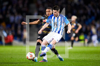 2022-02-24 - Igor Zubeldia of Real Sociedad competes for the ball with Christopher Nkunku of RB Leipzig during the UEFA Europa League, Play-off, 2nd leg football match between Real Sociedad and RB Leipzig on February 24, 2022 at Anoeta stadium in San Sebastian, Spain - REAL SOCIEDAD VS RB LEIPZIG - UEFA EUROPA LEAGUE - SOCCER
