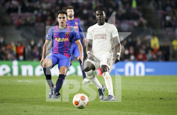 2022-03-10 - Bafetimbi Gomis of Galatasaray, Eric Garcia of Barcelona (left) during the UEFA Europa League, Round of 16, 1st leg football match between FC Barcelona and Galatasaray on March 10, 2022 at Camp Nou stadium in Barcelona, Spain - FC BARCELONA VS GALATASARAY - UEFA EUROPA LEAGUE - SOCCER