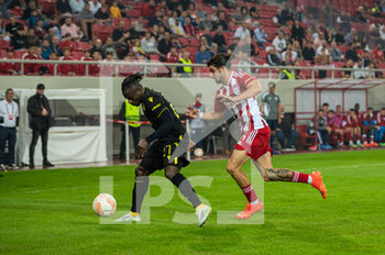2022-11-03 - MOSES SIMON (L) of FC Nantes competing with THANASIS ANDROUTSOS of Olympiacos FC during the UEFA Europa League group G match between Olympiacos FC v FC Nantes at the Karaiskakis Stadium on November 3, 2022 in Athens, Greece - OLYMPIACOS VS NANTES - UEFA EUROPA LEAGUE - SOCCER