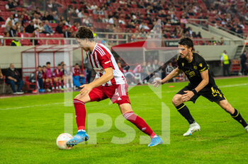 2022-11-03 - PANAGIOTIS RETSOS of Olympiacos FC competing with SÉBASTIEN CORCHIA (L) of FC Nantes during the UEFA Europa League group G match between Olympiacos FC v FC Nantes at the Karaiskakis Stadium on November 3, 2022 in Athens, Greece. - OLYMPIACOS VS NANTES - UEFA EUROPA LEAGUE - SOCCER