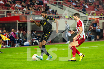 2022-11-03 - MARCUS COCO (L) of FC Nantes competing with SIME VRSALJKO of Olympiacos FC during the UEFA Europa League group G match between Olympiacos FC v FC Nantes at the Karaiskakis Stadium on November 3, 2022 in Athens, Greece. - OLYMPIACOS VS NANTES - UEFA EUROPA LEAGUE - SOCCER