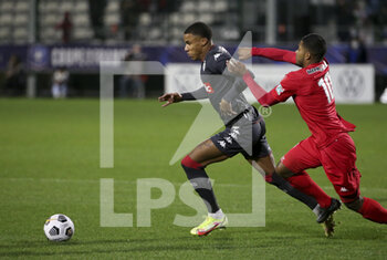 2022-01-02 - Ismail Jakobs of Monaco, Garland Gbelle of QRM during the French Cup, round of 32, football match between Quevilly Rouen Metropole (QRM) and AS Monaco (ASM) on January 2, 2022 at Stade Robert Diochon in Le Petit-Quevilly near Rouen, France - QUEVILLY ROUEN METROPOLE (QRM) VS AS MONACO (ASM) - FRENCH CUP - SOCCER