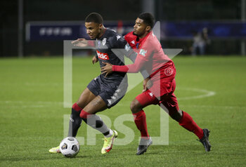 2022-01-02 - Ismail Jakobs of Monaco, Garland Gbelle of QRM during the French Cup, round of 32, football match between Quevilly Rouen Metropole (QRM) and AS Monaco (ASM) on January 2, 2022 at Stade Robert Diochon in Le Petit-Quevilly near Rouen, France - QUEVILLY ROUEN METROPOLE (QRM) VS AS MONACO (ASM) - FRENCH CUP - SOCCER