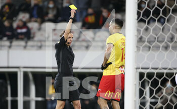 2022-01-22 - Referee Stephanie Frappart gives a yellow card to Facundo Medina of Lens during the French championship Ligue 1 football match between RC Lens (RCL) and Olympique de Marseille (OM) on January 22, 2022 at Stade Bollaert-Delelis in Lens, France - RC LENS VS OLYMPIQUE DE MARSEILLE - FRENCH LIGUE 1 - SOCCER