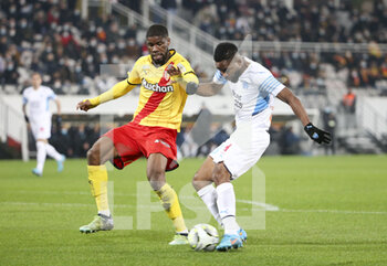 2022-01-22 - Cedric Bakambu of Marseille scores his goal despite Kevin Danso of Lens during the French championship Ligue 1 football match between RC Lens (RCL) and Olympique de Marseille (OM) on January 22, 2022 at Stade Bollaert-Delelis in Lens, France - RC LENS VS OLYMPIQUE DE MARSEILLE - FRENCH LIGUE 1 - SOCCER