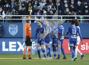 2022-02-27 - Referee Francois Letexier gives a yellow card to Adil Rami of Troyes during the French championship Ligue 1 football match between ESTAC Troyes and Olympique de Marseille (OM) on February 27, 2022 at Stade de l'Aube in Troyes, France - ESTAC TROYES VS OLYMPIQUE DE MARSEILLE - FRENCH LIGUE 1 - SOCCER