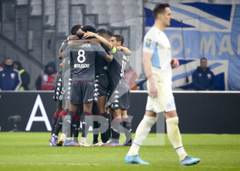 2022-03-06 - Players of Monaco celeebrate the winning goal while Arkadiusz Milik of Marseille looks on during the French championship Ligue 1 football match between Olympique de Marseille (OM) and AS Monaco (ASM) on March 6, 2022 at Velodrome stadium in Marseille, France - OLYMPIQUE DE MARSEILLE (OM) VS AS MONACO (ASM) - FRENCH LIGUE 1 - SOCCER