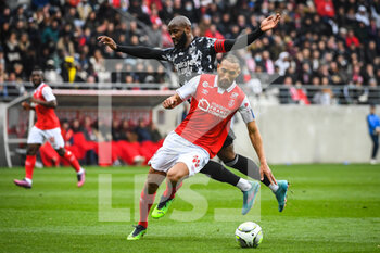2022-03-20 - Yunis ABDELHAMID of Reims and Moussa DEMBELE of Lyon during the French championship Ligue 1 football match between Stade de Reims and Olympique Lyonnais on March 20, 2022 at Auguste Delaune stadium in Reims, France - STADE DE REIMS VS OLYMPIQUE LYONNAIS - FRENCH LIGUE 1 - SOCCER